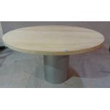 A 20th century oak dining table, the circular top on metal base, 139cm diameter x 73cm high.