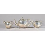 A late 19th century Chinese silver three piece tea set, Tuck Chang, Shanghai,