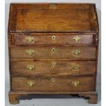 An 18th century and later oak bureau of four long graduated drawers on ogee bracket feet,