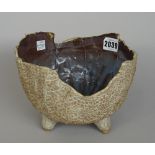 A post war studio pottery bowl, the exterior with a textured appearance beneath an irregular rim,