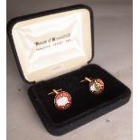 A pair of gold plated and enamel 1932 three piece cufflinks.
