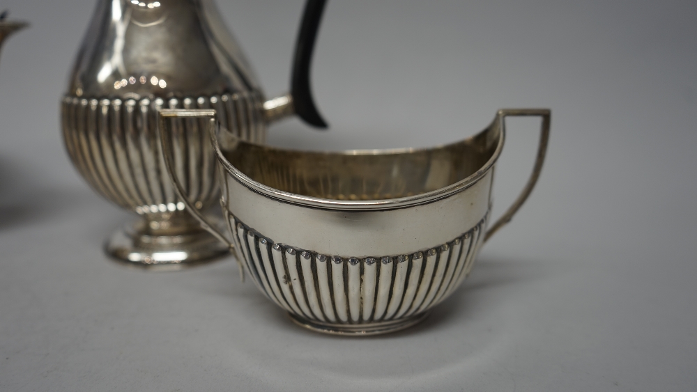 A silver composite four piece tea set, comprising; an oval teapot, with black composition fittings, - Image 2 of 6