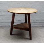 A George III oak and pine cricket table, with platform undertier, 77cm wide x 64cm high.