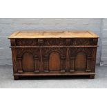 A 17th century style oak coffer, with triple panel lid and front, on stile feet,