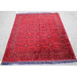 An Afghan Beluche rug, the madder field with three columns of five square sections,