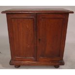 An early 20th century hardwood collectors chest with cupboard doors and four drawers,