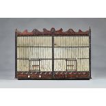 A 19th century birdcage, in the American "Tramp Art" manner, 82cms wide, 57.5cms high.