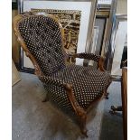 A Victorian mahogany framed open armchair with serpentine seat on scroll supports,