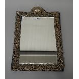 A late Victorian silver mounted strut backed mirror, of arched rectangular form,