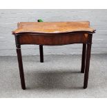 A George III mahogany serpentine card table on channelled block supports, 89cm wide x 74cm high.