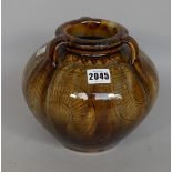 A tri-handled vase with ash glaze over stamped and incised body, 19cm high.