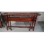 A pair of 20th century hardwood console tables, with glass inset top over two drawers,