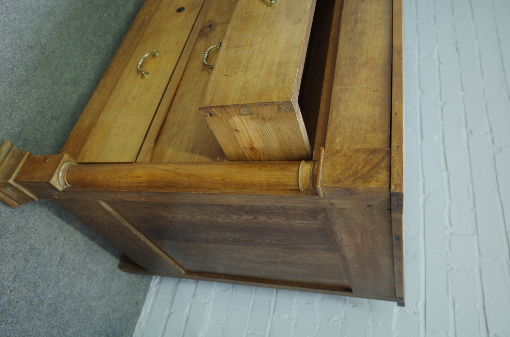 A 19th century fruitwood commode of four long drawers flanked by turned columns, - Image 2 of 3