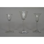 Three plain-stemmed wine glasses, mid 18th century,