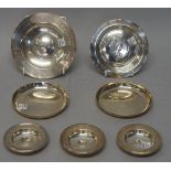 Silver, comprising; a pair of circular plain dishes, London 1963, a circular dish,