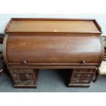 A Victorian mahogany roll top desk with fitted interior over six pedestal drawers,
