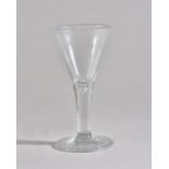 A tall plain-stemmed wine glass, mid-18th century,
