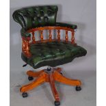 A 20th century green leather upholstered tub back office swivel chair on a five point base,