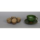 A cup and saucer, slip decorated terracotta with green glaze, scratched initials, 8cm high,