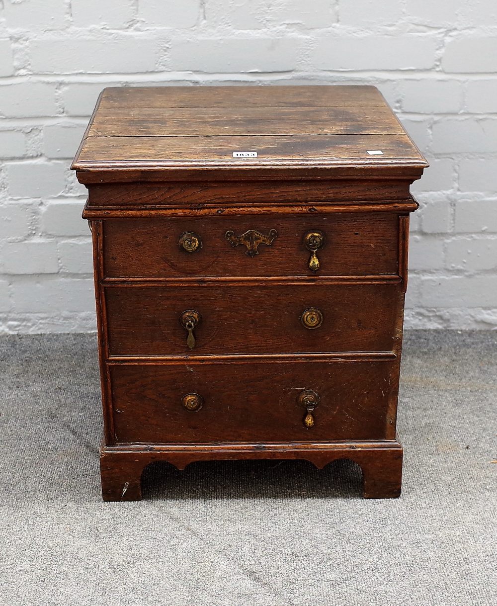 A George I oak close/box stool, lift up lid above dummy drawer front, 47cms wide, 57.5cms high.