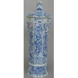 A tall Dutch Delft blue and white vase and cover, 18th/19th century, of ribbed octagonal form,