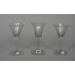 A plain-stemmed wine glass, mid 18th century, the bell bowl with tear in solid base, folded foot,