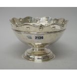 A silver centrepiece bowl, decorated with a band of hearts below a shaped rim,
