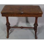 A Victorian walnut foldover card table on dual ended supports, 86cm wide x 68cm high.