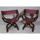 A pair of 20th century Savonarola chairs with maroon leather upholstery, 58cm wide x 69cm high.