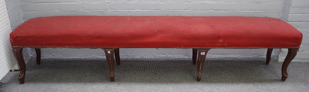 A large 19th century French rectangular stool on eight brown painted cabriole supports,