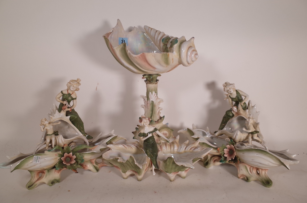 A 20th century three piece ceramic centre piece with cherubs,