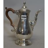 An early George III silver coffee pot, of baluster form, raised on a plain circular foot,