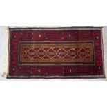 An Afghan rug, 184cm x 113cm and two Beluchi rugs, 136cm x 77cm, 175cm x 92cm, (3).