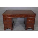 A 20th century mahogany pedestal desk, with tooled brown leather top, 136cm wide x 80cm high.