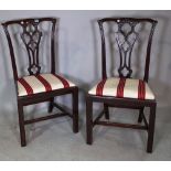 A pair of mid-18th century style mahogany dining chairs with pierced splat on square supports,