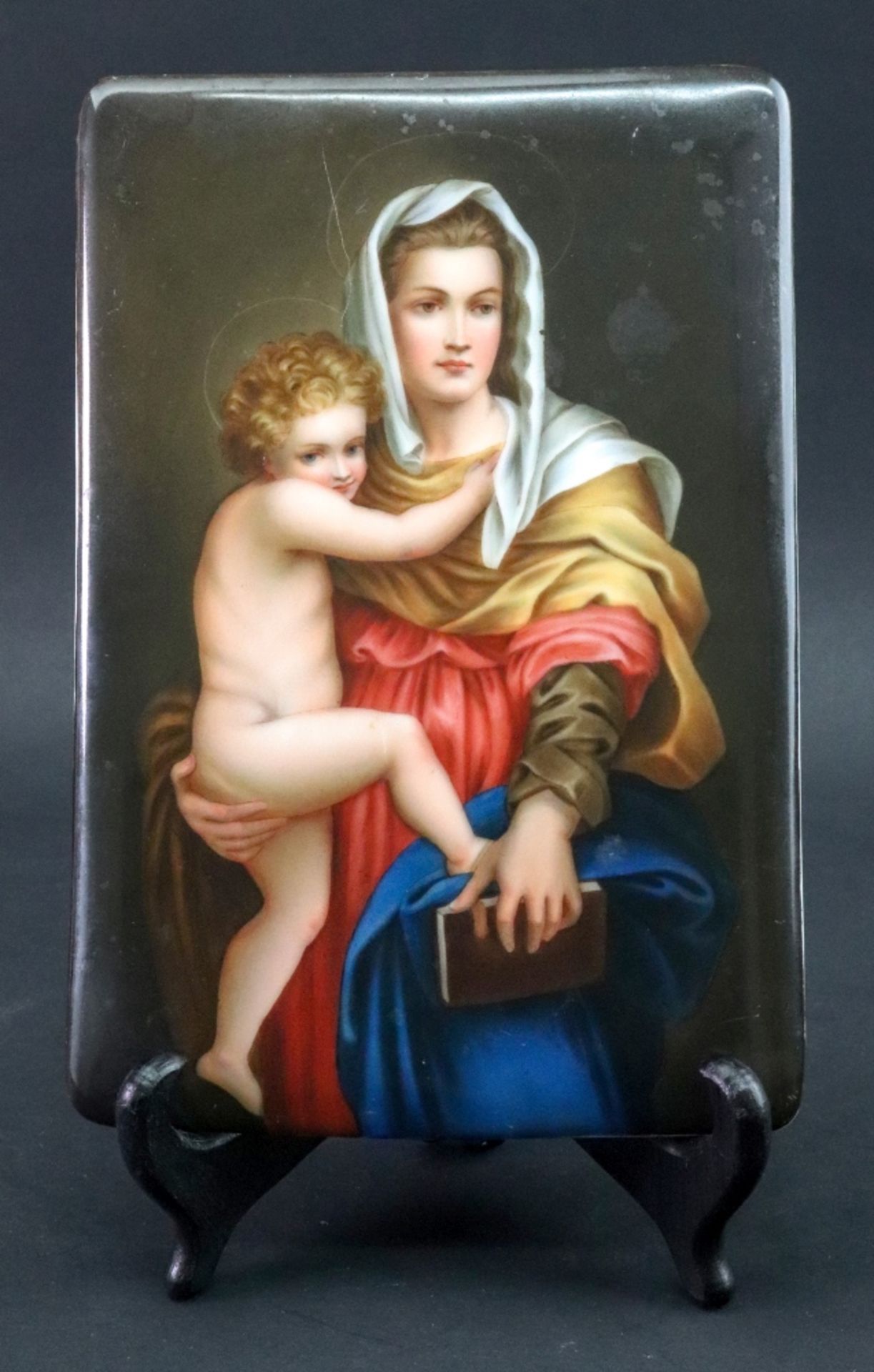 A continental rectangular porcelain plaque, late 19th century, painted with the Madonna and child,