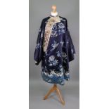 A Chinese dark blue and ivory silk mandarin coat, late 19th century, embroidered with mons,