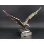 A cast silvered metal figure of an eagle, with outstretched wings,
