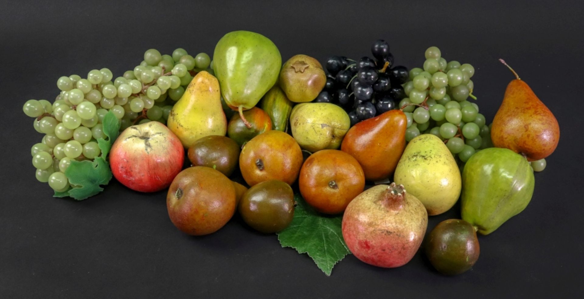 A collection of painted plaster models of fruit,