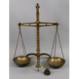 A set of brass beam scales, Degrave & Co makers London, with circular pans, on a tripod base,