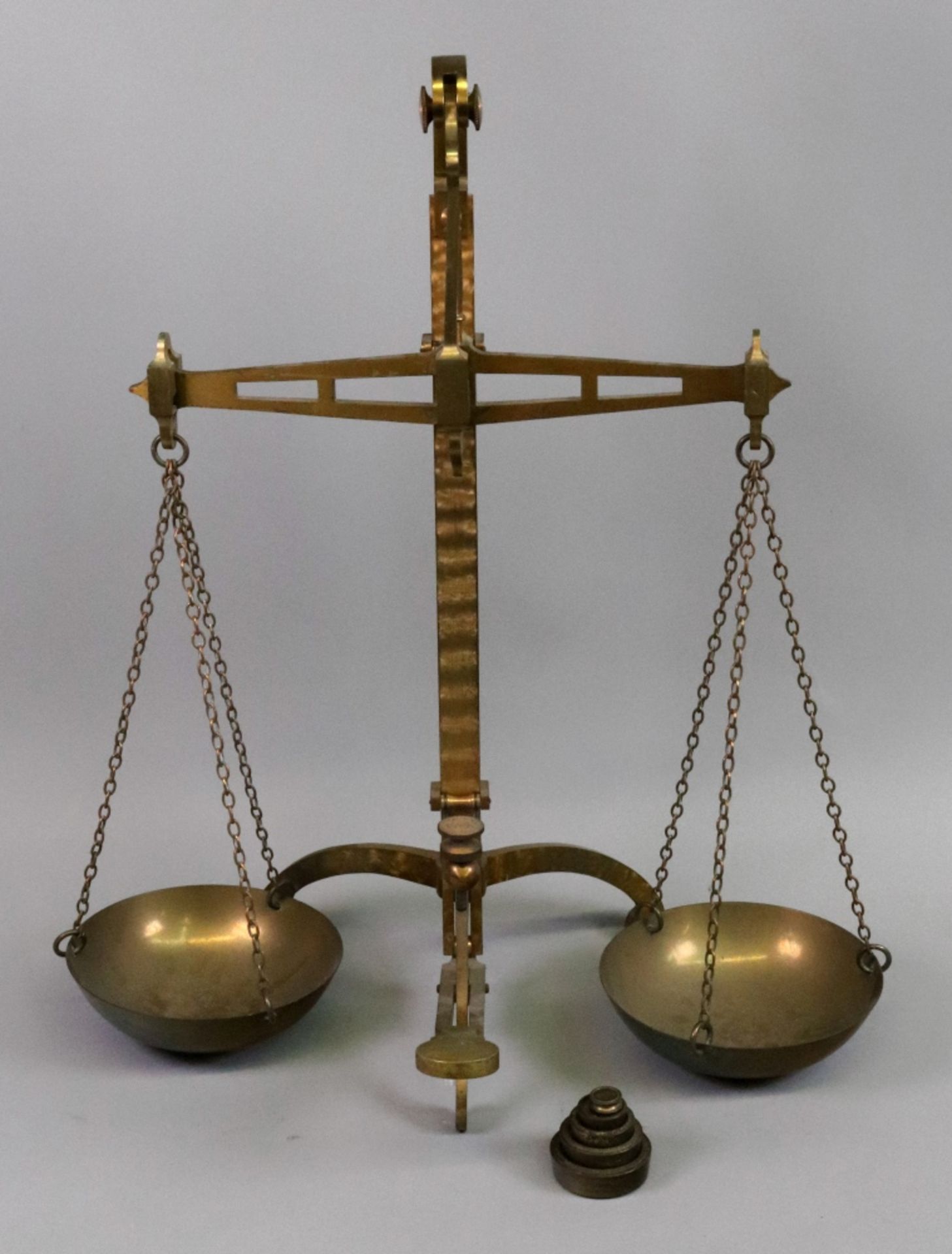 A set of brass beam scales, Degrave & Co makers London, with circular pans, on a tripod base,