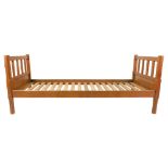 A pair of Robert Thompson 'The Mouseman' oak single beds, with slatted head and footboards,