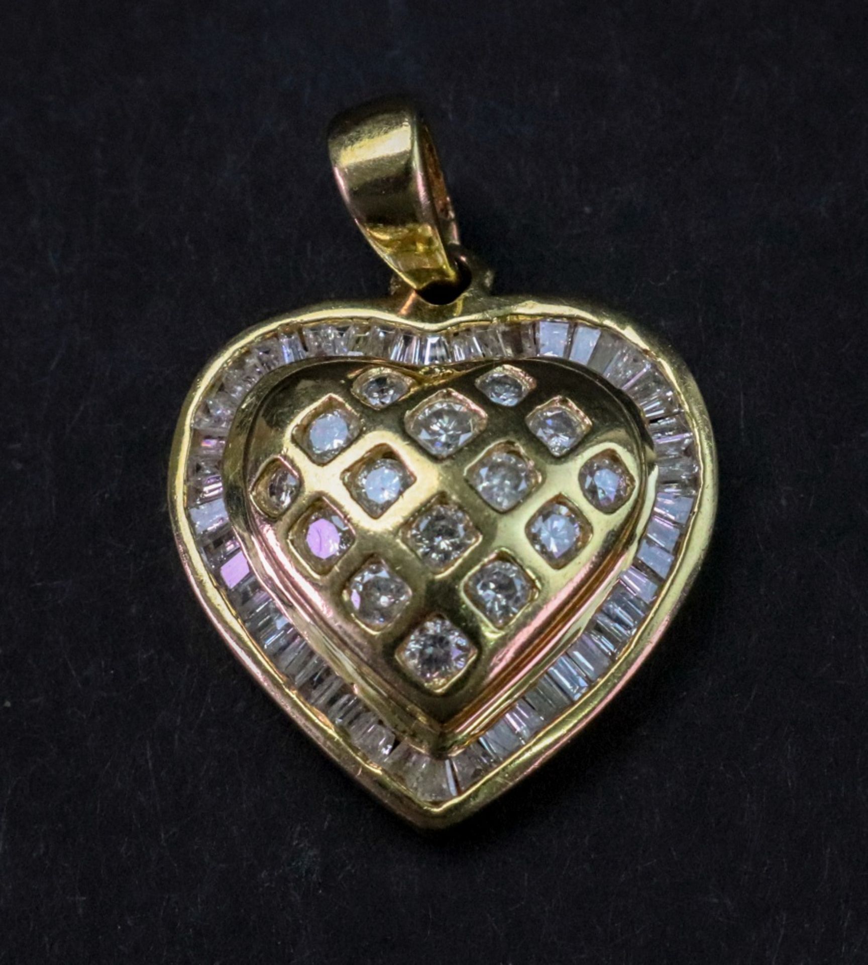 A modern gold and diamond set heart shape pendant,