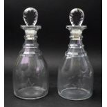 A pair of George III glass maul shape decanters, with stepped necks and faceted stoppers,