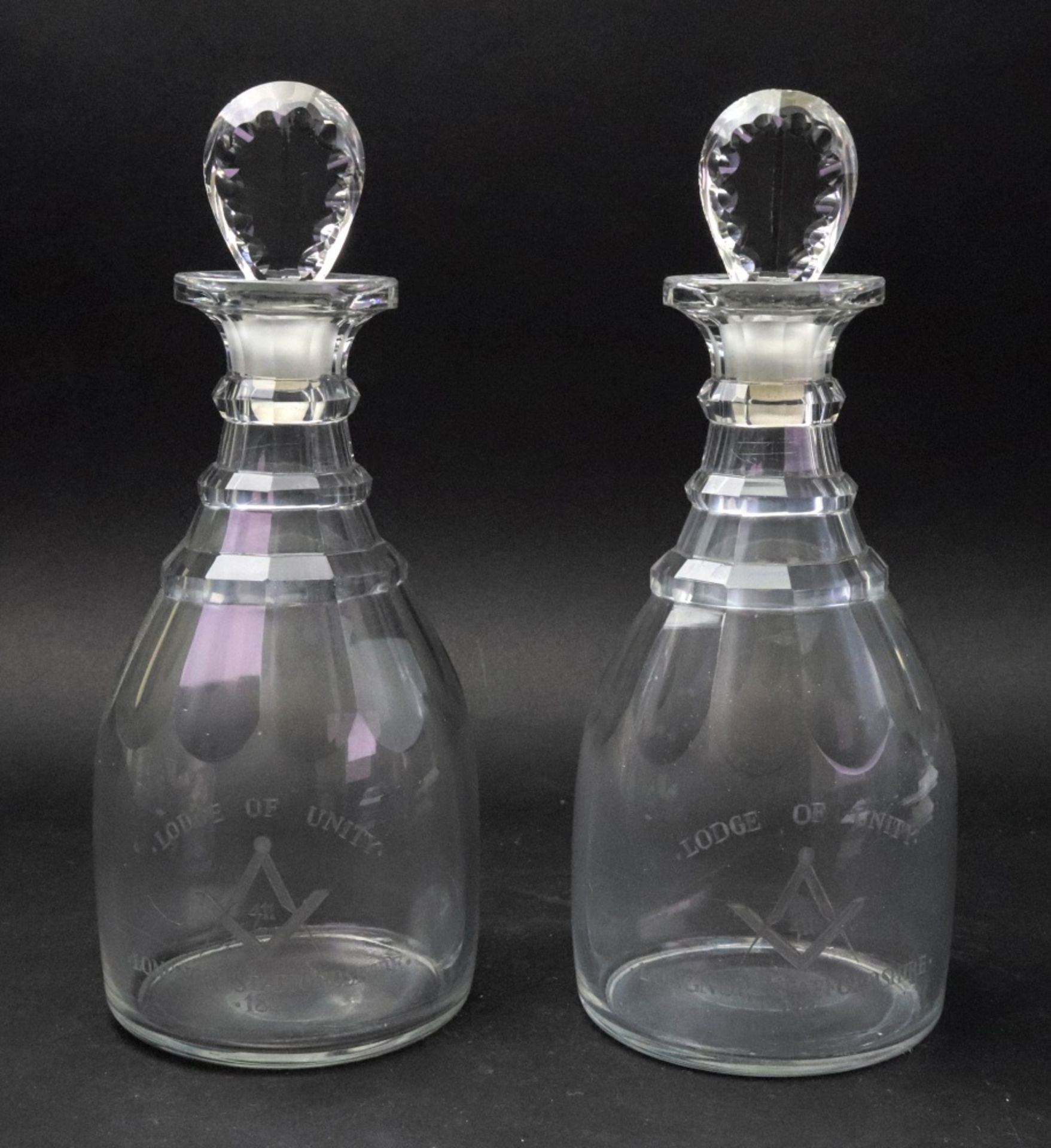 A pair of George III glass maul shape decanters, with stepped necks and faceted stoppers,