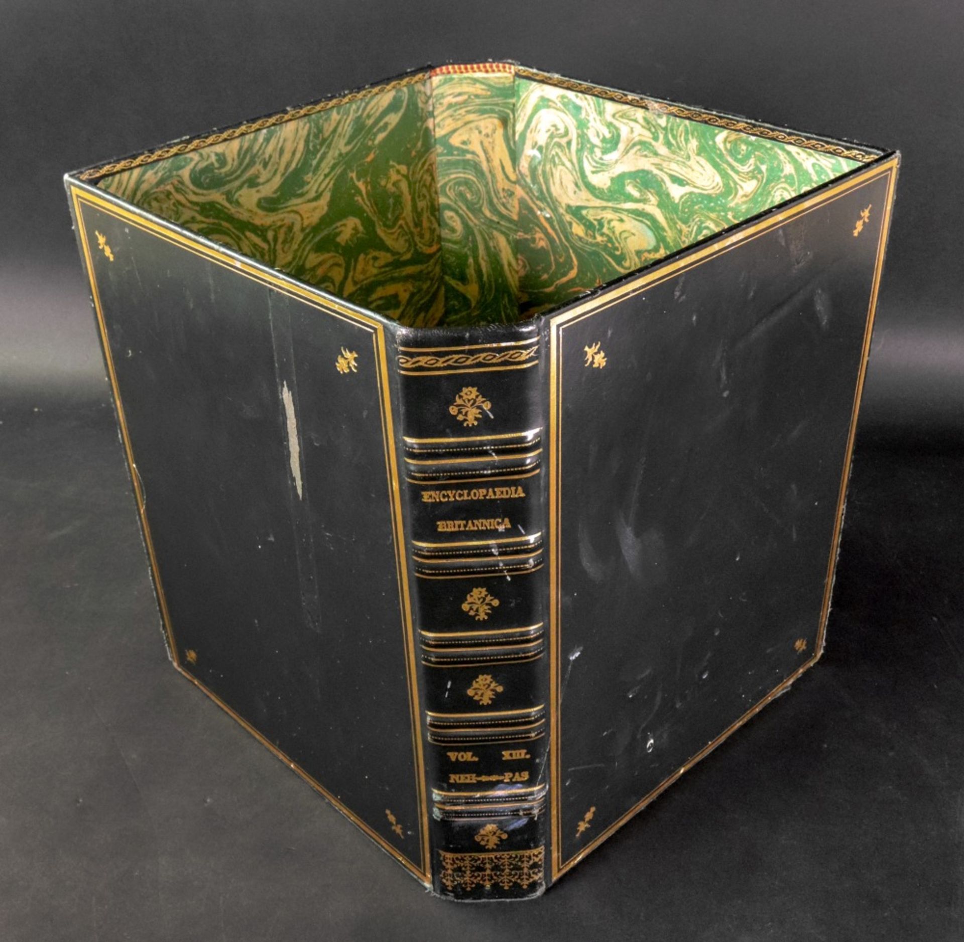 A waste bin formed from two green leather gilt tooled covers from the Encyclopaedia Britannica, 28.