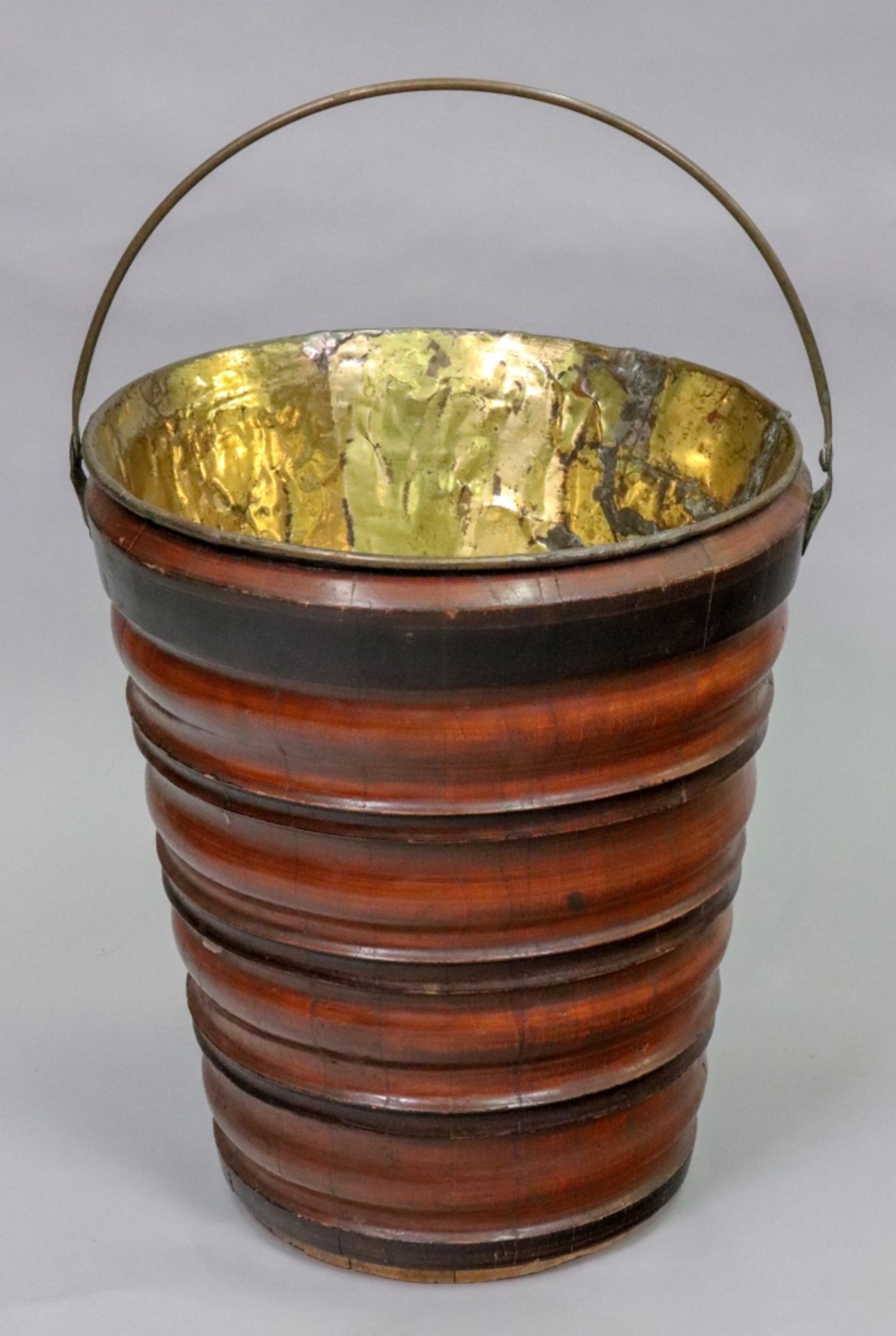 A Dutch walnut bucket, 19th century, with brass swing handle,