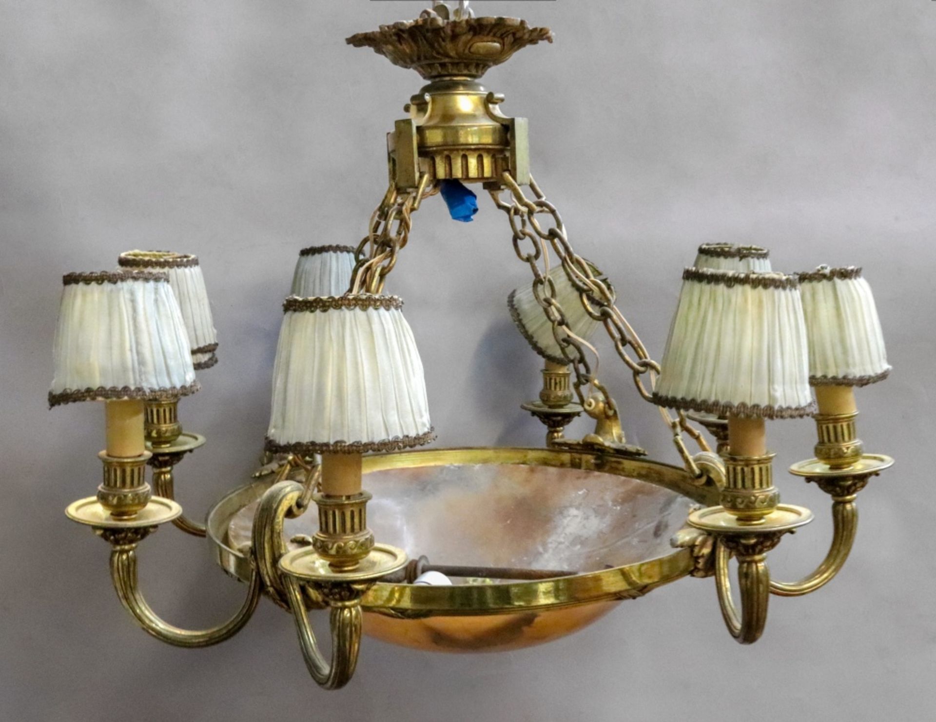 A French gilt metal eight light chandelier, early 20th century, with domed circular alabaster shade,