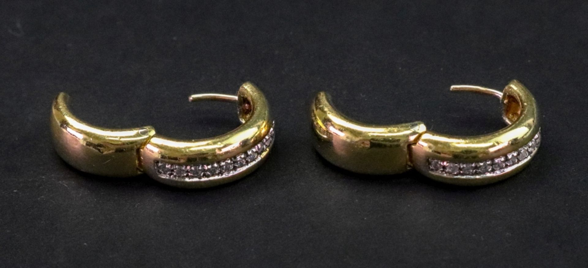 A pair of gold hinged hoop earrings, set row of single cut diamonds, makers marks, stamped ‘750', 8.