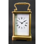 A large brass cased carriage clock, early 20th century, the white enamel dial with Roman numerals,